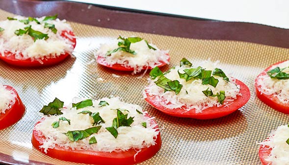 Top tomato slices with Parmesan, basil, salt, pepper and olive oil. Bake for 10-15 minutes.
