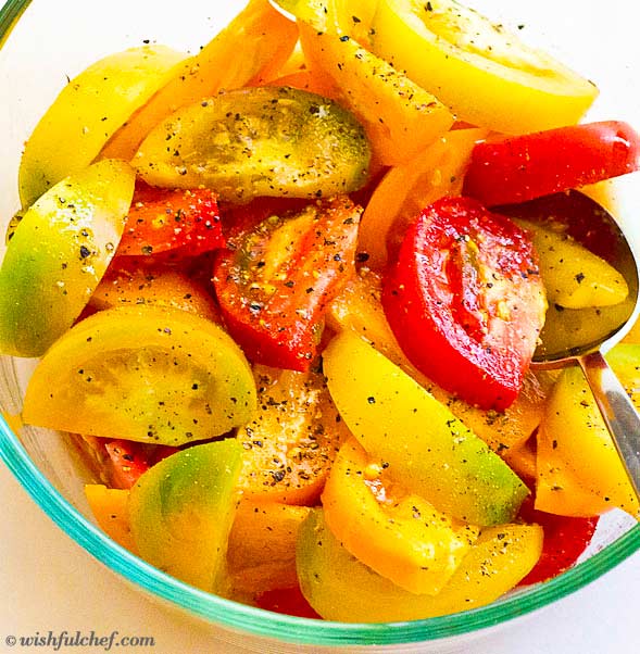 Place tomato wedges in a bowl and toss with olive oil, vinegar, salt and pepper.