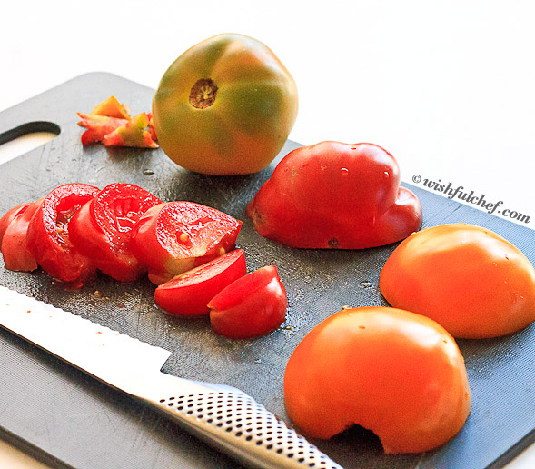 Core and slice tomatoes in half, then cut into wedges. 